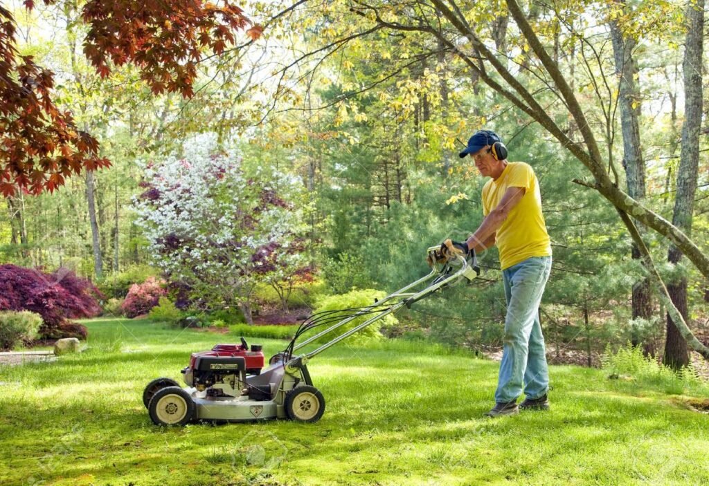 Man pushing lawn mower