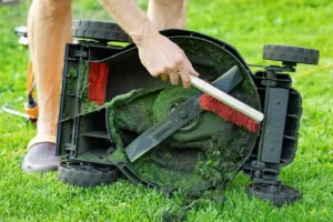 Mower deck being cleaned at Legacy Small Engines