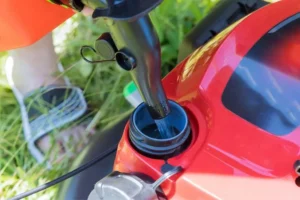 Filling lawn mower with gas at Legacy Small Engines repair shop in Stittsville Ottawa